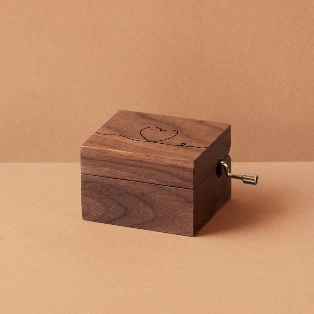 Walnut wood music box with a heart and the thread of fate